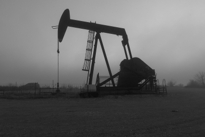 An oilfield rocking horse contrasted against a morning fog