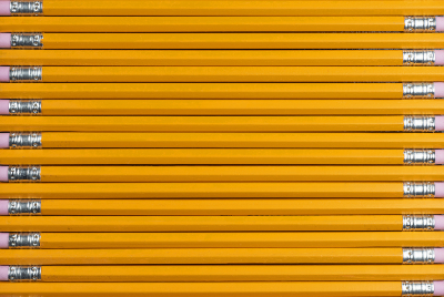 Unsharpened, yellow pencils lined up neatly